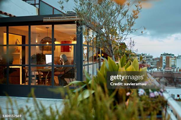 mid 60s female freelancer working from home - mid distance stock pictures, royalty-free photos & images