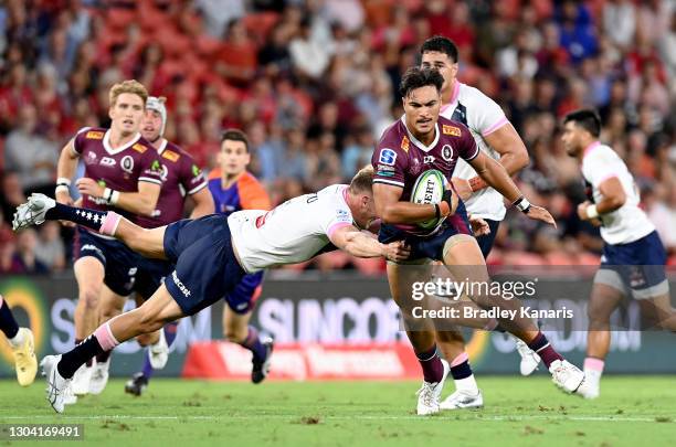 Jordan Petaia of the Reds breaks away from the defence during the round two Super Rugby AU match between the Melbourne Rebels and the Queensland Reds...