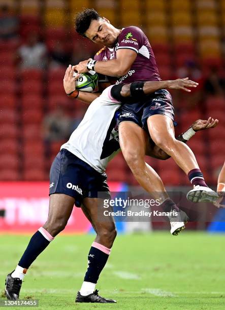 Jordan Petaia of the Reds is tackled in the air by Marika Koroibete of the Melbourne Rebels who is penalised for the tackle during the round two...