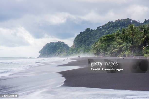 black sand beach, playa hermosa, costa rica - costa rica beach stock pictures, royalty-free photos & images