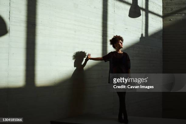 woman sunbathing inside a building - soul city ストックフォトと画像