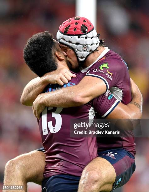 Hunter Paisami is kissed by Fraser McReight of the Reds as they celebrate victory after the round two Super Rugby AU match between the Melbourne...