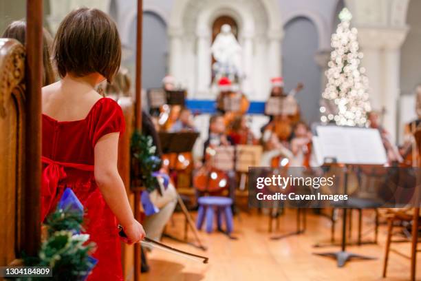 a small girl stands with cello bow in hand waiting her turn to perform - stage fright stock pictures, royalty-free photos & images