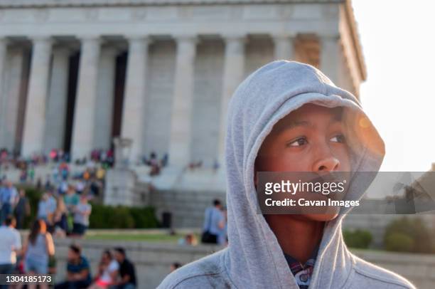 young african american male tween in front of lincoln memorial - anti racism stock pictures, royalty-free photos & images