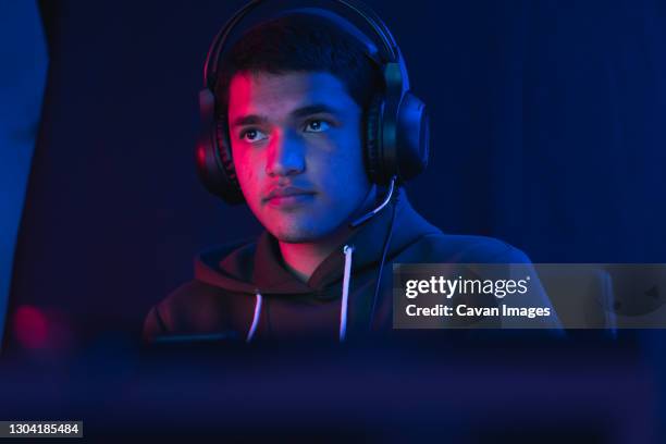 young man doing a live video game sharing online. - ecuador people stock pictures, royalty-free photos & images