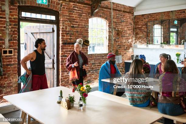 multi-ethnic group of yoga students in refectory style cafe - open day 10 stock pictures, royalty-free photos & images