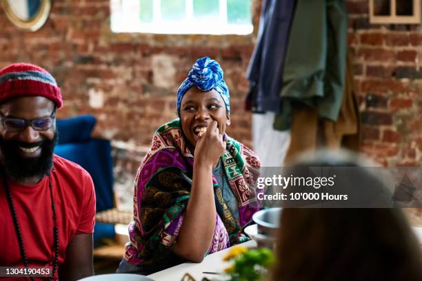 two people laughing and talking at a table over lunch - retreat women diverse stock-fotos und bilder