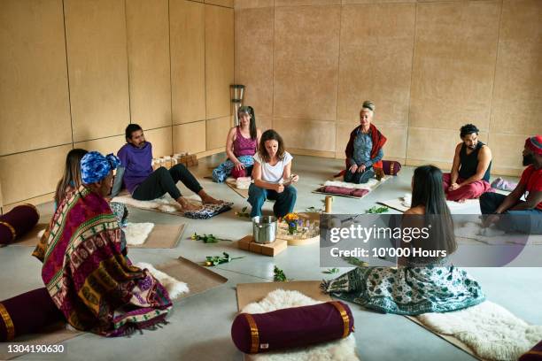 yoga group watching instructor prepare tea ceremony - smudging ceremony stock pictures, royalty-free photos & images