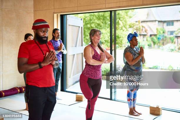 yoga students in mountain pose in studio - disabilitycollection stock pictures, royalty-free photos & images