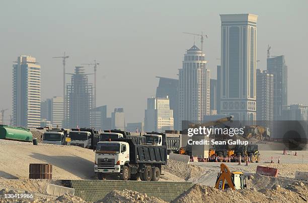 Trucks stand at a construction site across from skyscrapers in the budding new financial district on October 26, 2011 in Doha, Qatar. Qatar, which is...