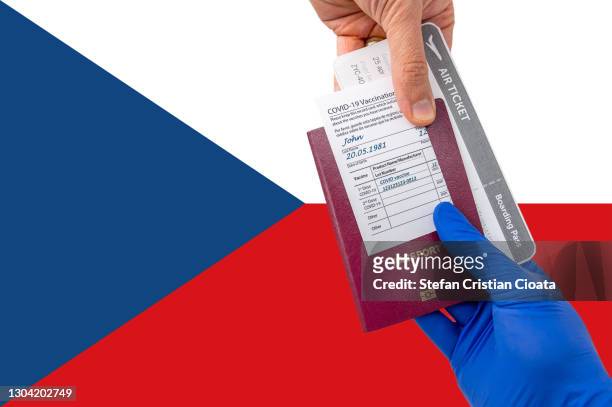 human hand holding a passport and vaccination certificate - czech republic flag stock pictures, royalty-free photos & images