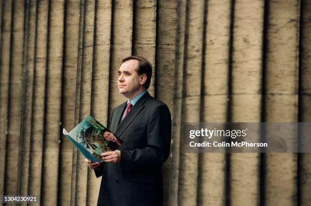 The Scottish National Party leader Alex Salmond poses for photographs with a copy of the SNP's 1999 Scottish Parliament elections at the former Royal...