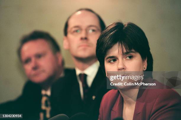 The Scottish National Party's Nicola Sturgeon listening to her party leader Alex Salmond addressing the media at the launch of the SNP's 1999...