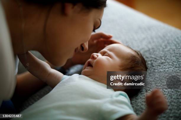 mother and crying newborn baby - moms crying in bed stock pictures, royalty-free photos & images