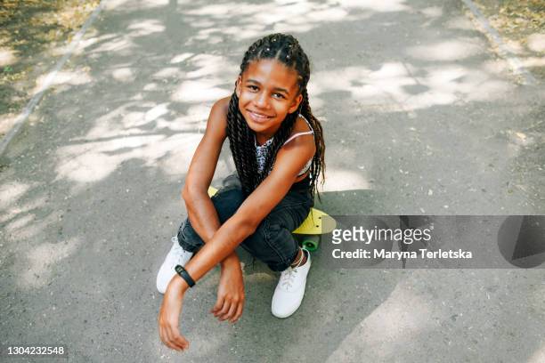 beautiful dark-skinned teenager girl in the park. - 13 year old black girl stock pictures, royalty-free photos & images