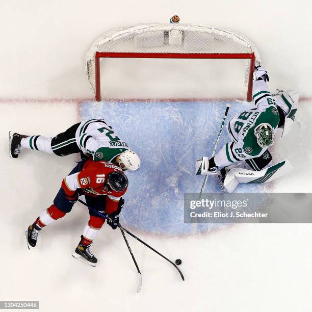 Goaltender Jake Oettinger and Jamie Oleksiak of the Dallas Stars defend the net against Aleksander Barkov of the Florida Panthers at the BB&T Center...