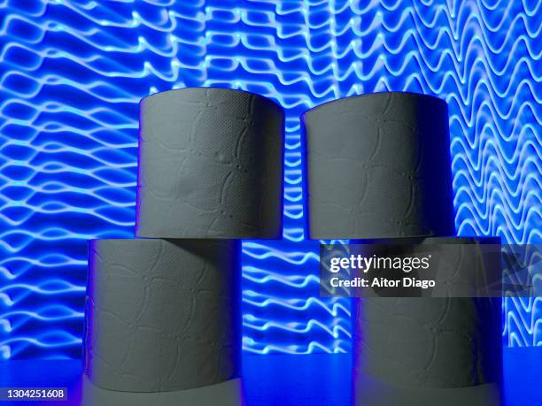 stacked toilet paper rolls. it could be the shape of two persons.  modern blue lines in the background. - traveler's diarrhoea stock pictures, royalty-free photos & images