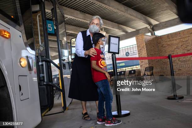 Sister Norma Pimentel, Executive Director of Catholic Charities of the Rio Grande Valley escorts a young asylum seeker upon his entry into the United...