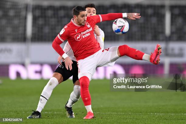 Anthony Knockaert of Nottingham Forest is challenged by Lee Buchanan of Derby County during the Sky Bet Championship match between Derby County and...