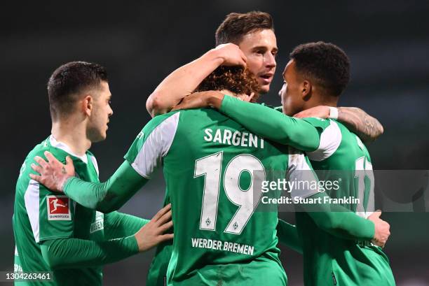 Goalscorer Josh Sargent of Werder Bremen is congratulated by team mates Milot Rashica , Marco Friedl and Felix Agu after scoring his team's second...