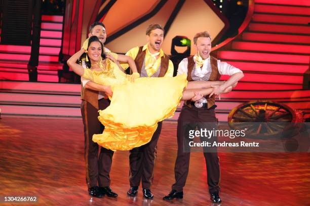 Robert Beitsch, Nicolas Puschmann and Vadim Garbuzov hold Vanessa Neigert as they perform on stage during the pre-show "Wer tanzt mit wem? Die grosse...