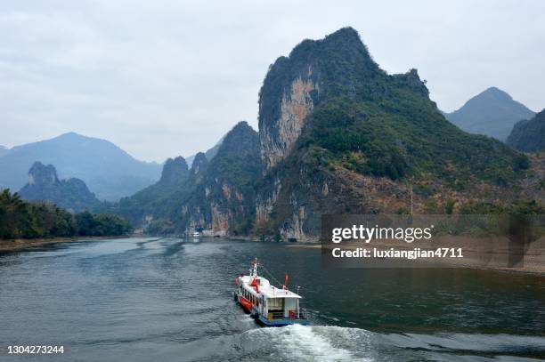majestic lijiang karst peak-forest landform(cloudy sky) - limestone karst mountain scenery yangshuo stock pictures, royalty-free photos & images