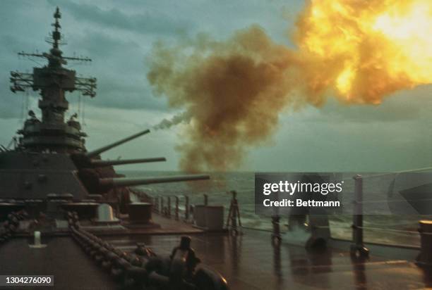 The USS New Jersey, an Iowa-class battleship serving the United States Navy, firing 16-inch shells into the Demilitarized Zone from the waters off...