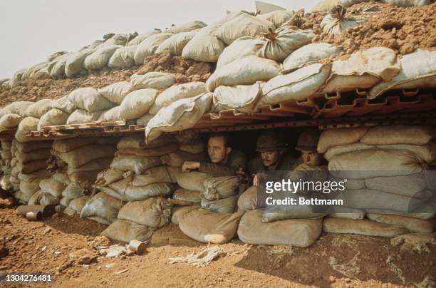 Officers of the United States Marines Corps take shelter in a sandbagged bunker as shelling resumes over Khe Sanh Combat Base, a US Marines outpost...