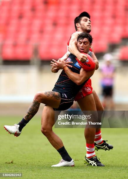 Tim Taranto of the Giants contests the ball with Lewis Melican of the Swans during the AFL Practice Match between the GWS Giants and the Sydney Swans...