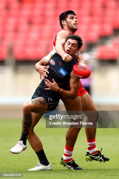 Tim Taranto of the Giants contests the ball with Lewis Melican of the Swans during the AFL Practice Match between the GWS Giants and the Sydney Swans...