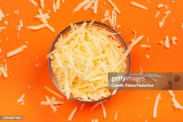 grated cheese in the bowl. - grated stock pictures, royalty-free photos & images