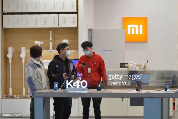Customers try out Redmi K40 smartphones at a Xiaomi Store on February 26, 2021 in Shenyang, Liaoning Province of China.