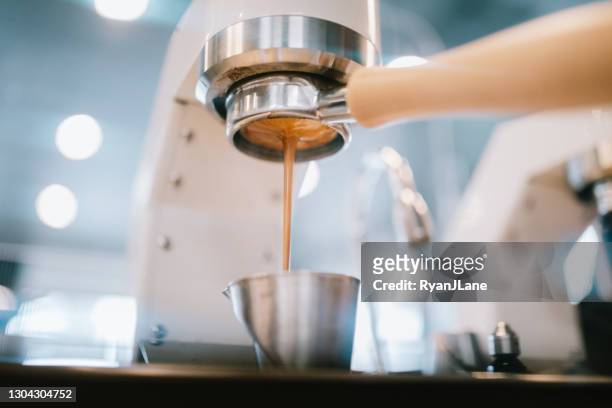fresh hot shot of espresso being pulled in cafe - crema stock pictures, royalty-free photos & images