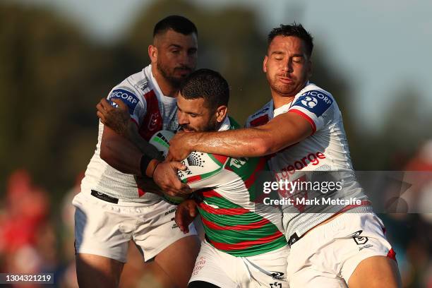 Adam Reynolds of the Rabbitohs Is tackled during the Charity Shield & NRL Trial Match between the South Sydney Rabbitohs and the St George Illawarra...