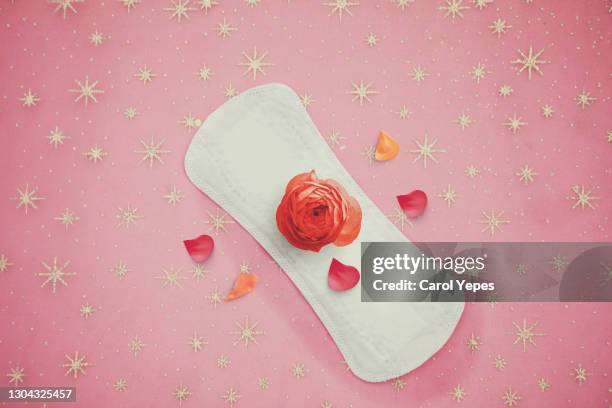 sanitary pad background in pink colorful background and some flowers - sports period stockfoto's en -beelden