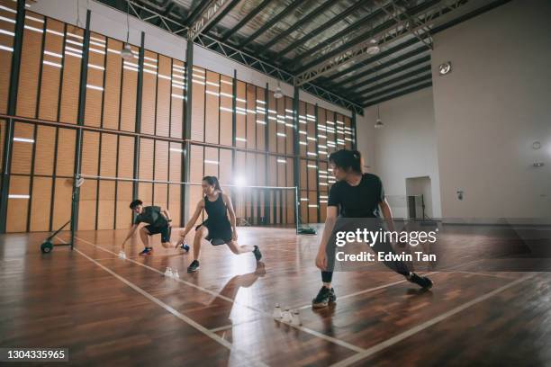 low angle asian chinese badminton players practicing in badminton court warm up exercise before practicing - warm up exercise indoor stock pictures, royalty-free photos & images