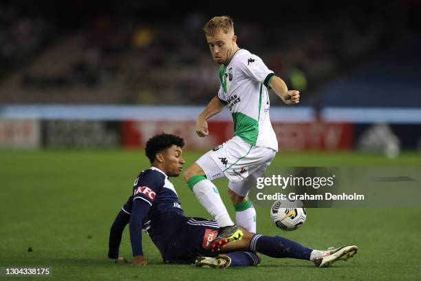 Connor Pain of Western United is tackled by Zaydan Bello of the Victory during the A-League match between the Melbourne Victory and Western United at...
