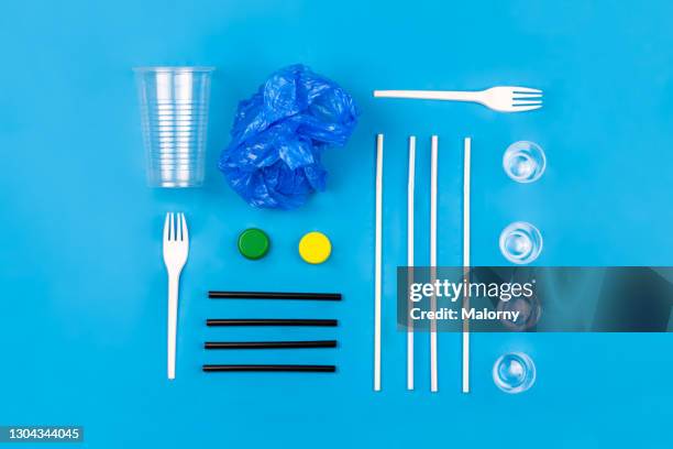 reduce plastic waste. diverse plastic waste on blue background. - disposable stock pictures, royalty-free photos & images