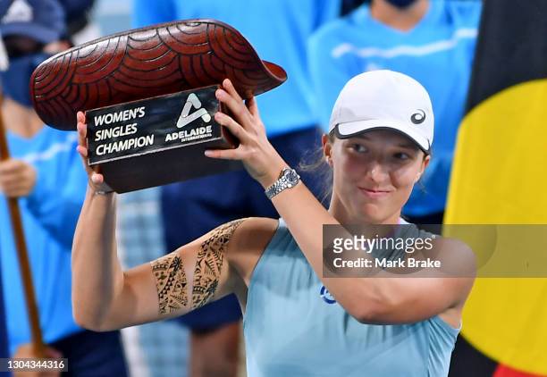 Iga Swiatek of Poland holds up the Adelaide International Womens Singles Champion trophy wearing her Rolex during day six of the Adelaide...