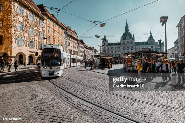 street view. tram on hauptplatz square in graz. - graz stock pictures, royalty-free photos & images