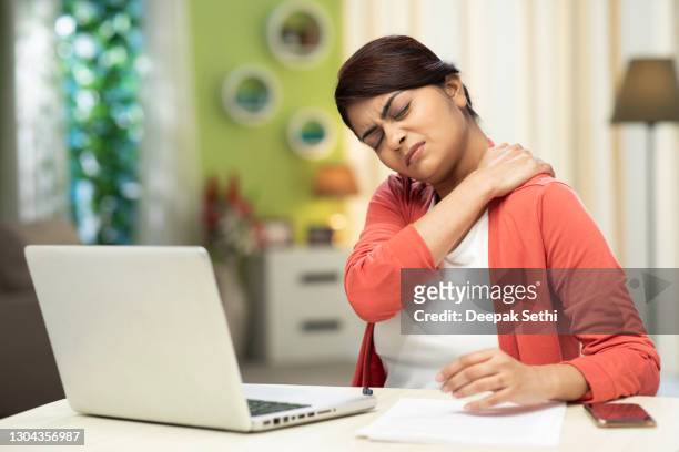 young women using laptop at home, stock photo - neck pain stock pictures, royalty-free photos & images
