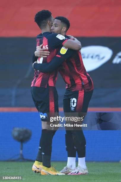 Arnaut Danjuma of AFC Bournemouth celebrates with teammate Junior Stanislas after scoring his team's first goal during the Sky Bet Championship match...