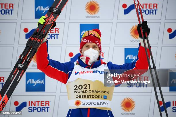 Gold medalist Alexander Bolshunov of Russian Ski Federation celebrates during the flower ceremony for the Men's Cross Country Skiathlon 15 km/15 km...