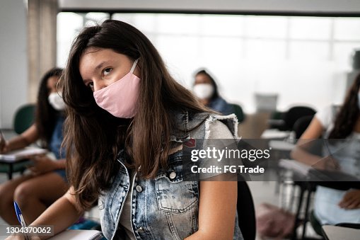 Girl studying at school - wearing protective face mask Girl studying at school - wearing protective face mask