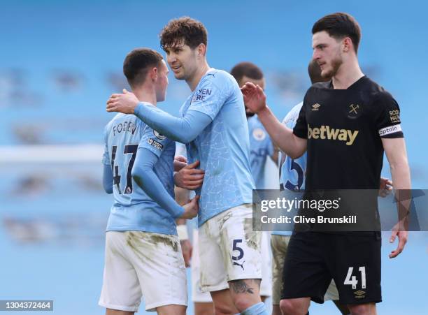 Phil Foden and John Stones of Manchester City celebrate following their team's victory in the Premier League match between Manchester City and West...