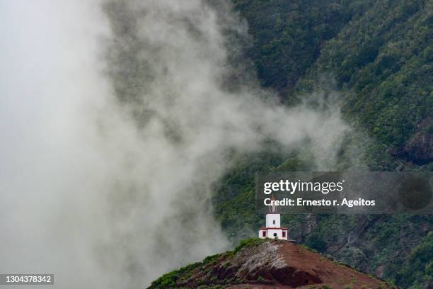 cloud covering joapira tower bell, el hierro, canary islands - hierro stock pictures, royalty-free photos & images