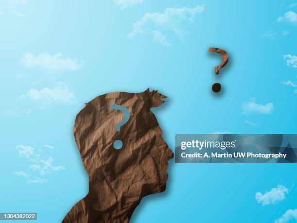 crumpled paper shaped as a human head and question mark on blue background with clouds. question concept. - manquestionmark stock pictures, royalty-free photos & images