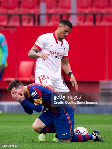 Diego Carlos of Sevilla FC competes for the ball with Lionel Messi of FC Barcelona during the La Liga Santander match between Sevilla FC and FC...