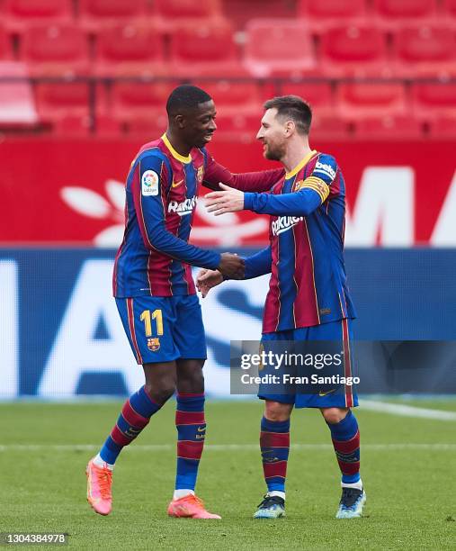 Ousmane Dembele and Lionel Messi of FC Barcelona celebrate Ousmane Dembele first goal during the La Liga Santander match between Sevilla FC and FC...