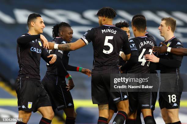 Anwar El Ghazi of Aston Villa celebrates with teammates Bertrand Traore and Tyrone Mings after scoring his team's first goal during the Premier...